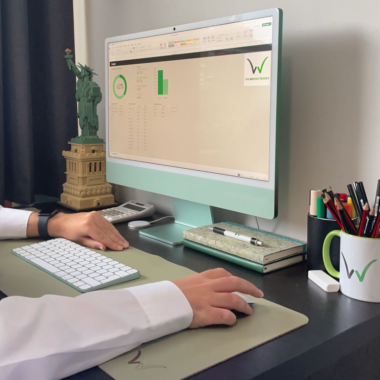 Lewis Wright sits at his desk looking at a spreadsheet